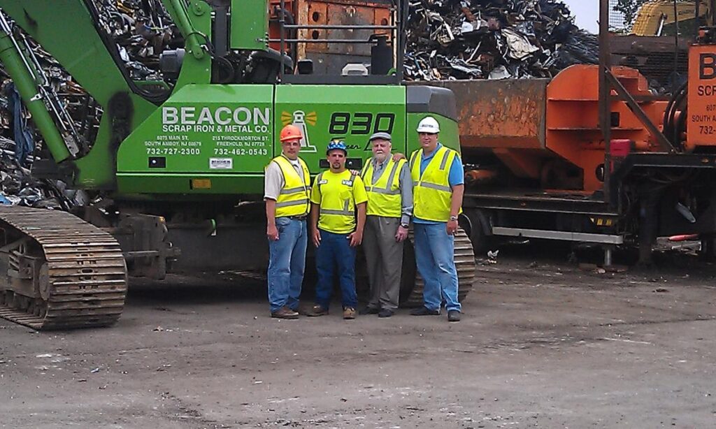 Welcoming the arrival of Beacon’s new SENNEBOGEN 830 R-HD are (left to right) Dominick Vecchiarelli, Sales Manager at Binder Machinery, Clyde Cameron III, William Smith Sr. and Jim Gill, Binder Machinery’s specialist in scrap processing equipment.